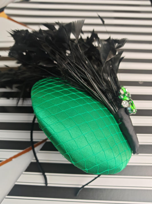 Elegant emerald green hat with cascading black feathers