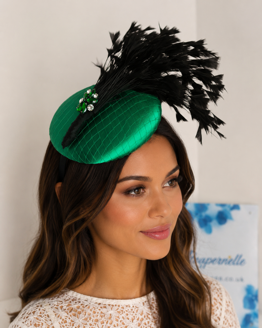 Elegant emerald green hat with cascading black feathers